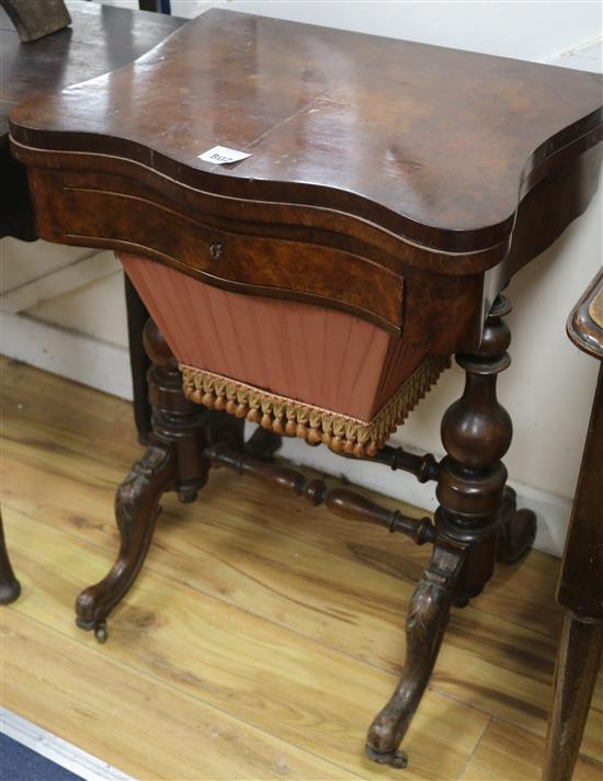 A Victorian walnut games / sewing table, H.73cm